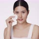 Attractive beautiful young Asian woman cleaning face with cotton pad isolated on white background. - VideoHive Item for Sale