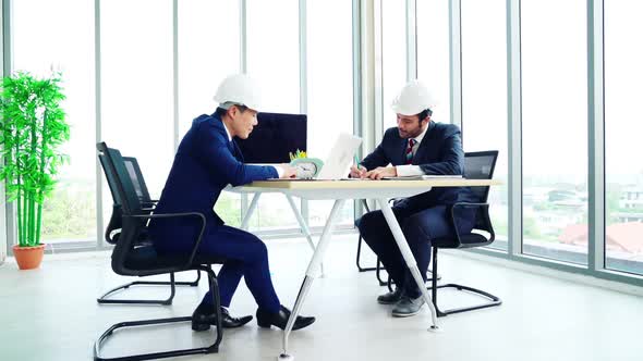 Engineer and Architect Meeting at Office Table