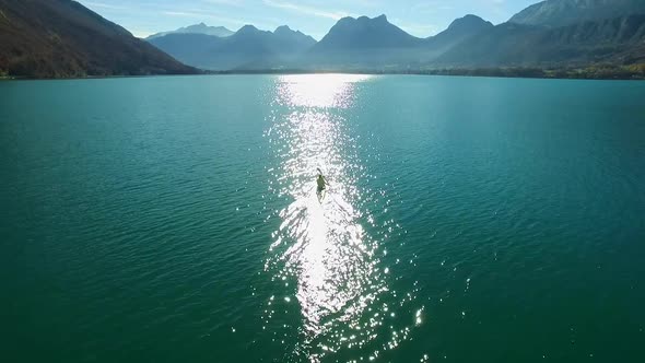 A kayaker paddles in a scenic mountain lake.