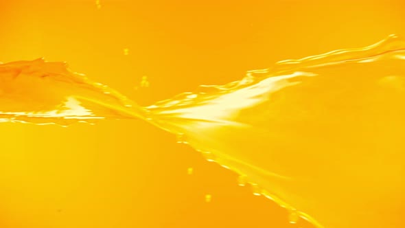 Super Slow Motion Shot of Orange Juice Spiral Splash at 1000Fps