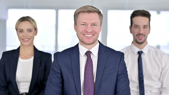Portrait of Professional Team Smiling at the Camera in Modern Office