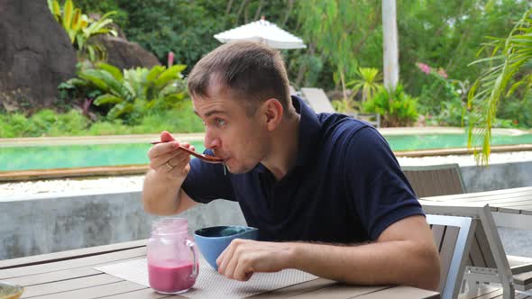 Young Pensive Male Eats Healthy Fruits Smoothie Bowl Think About Something