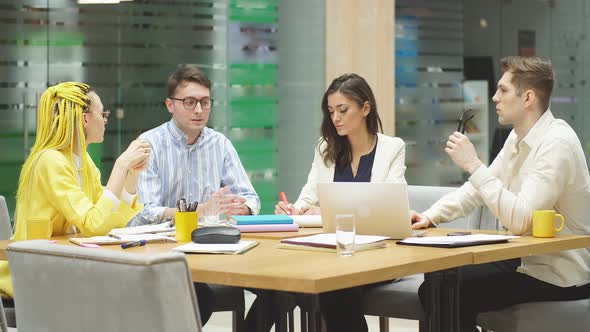 Young Stylish People Sharing with Knowledge, Information at Meeting