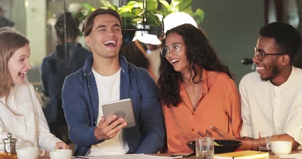 Cheerful Multi Ethnic People Looking at Tablet Screen and Laughing. Crop View of Happy Millennial