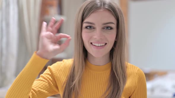 Portrait of Cheerful Creative Young Woman Doing OK Sign