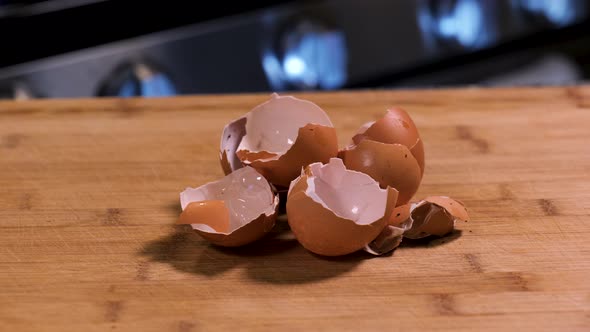 Eggshells on a cutting board in a kitchen