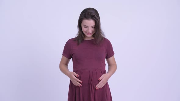 Happy Young Beautiful Pregnant Woman Smiling with Arms Crossed