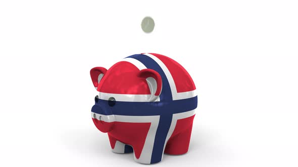 Coins Fall Into Piggy Bank Painted with Flag of Norway alt