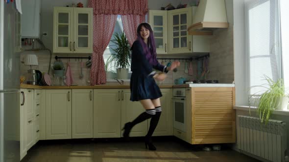 Young Beautiful Woman Dancing In The Kitchen At Home In A Japanese Costume