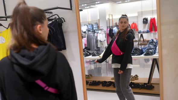 Pretty Young Woman Shopping in Clothes Store