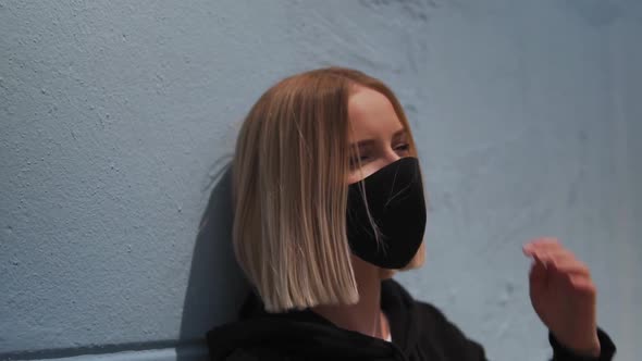 Close Up of Young Blonde Woman With Black Face Mask in Exterior, Slow Motion