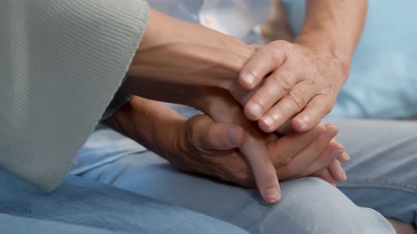 Close Up of Mature Couple Holding Hands Indoors