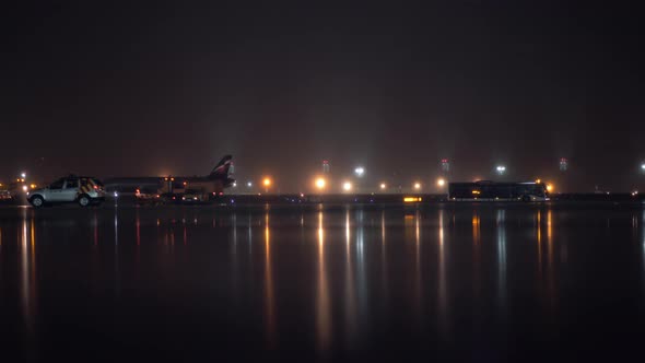Transport traffic in airport at night Lights reflection on wet asphalt