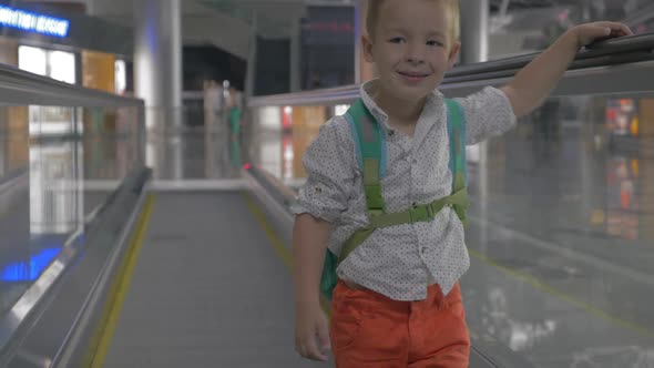 Cute Little Boy on Travelator in Airport