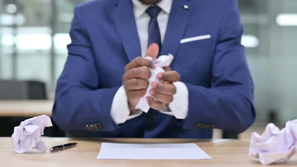 African Businessman Trying To Write, Torn Paper