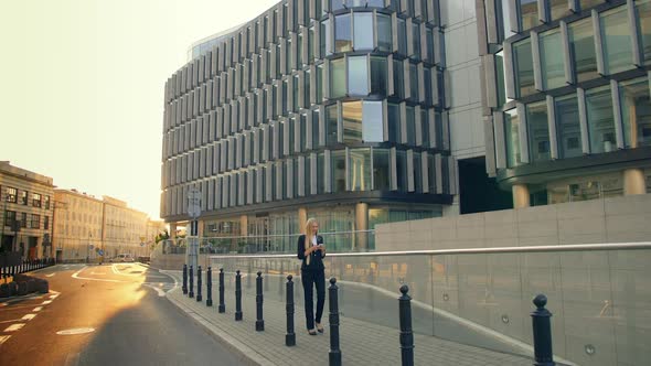 Modern Young Lady Walking on Contemporary Urban Street