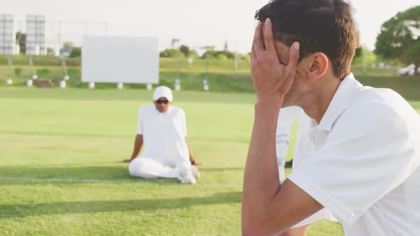 Cricket player holding his head after the match