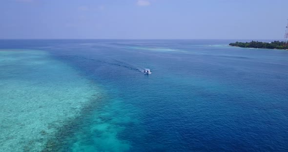 Daytime flying island view of a sandy white paradise beach and turquoise sea background in best qual