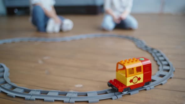 Kids Play with Wooden Railway. Child with Toy Train. Educational Toys for Young Children. Little Boy