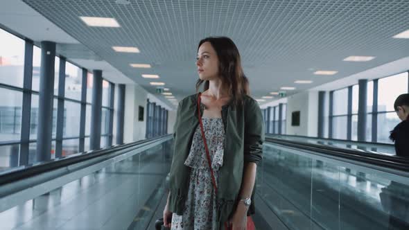 Attractive girl on the escalator