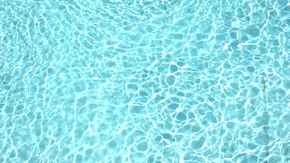 Pure Blue Water in the Swimming Pool with Light Reflections in Slow Motion