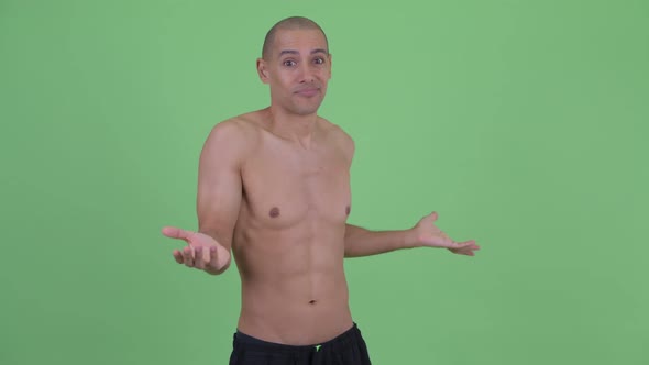 Confused Bald Multi Ethnic Shirtless Man Shrugging Shoulders