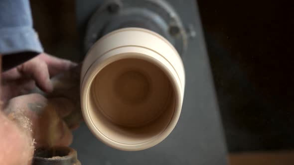 Carpenter Shaping Wood on Lathe Machine