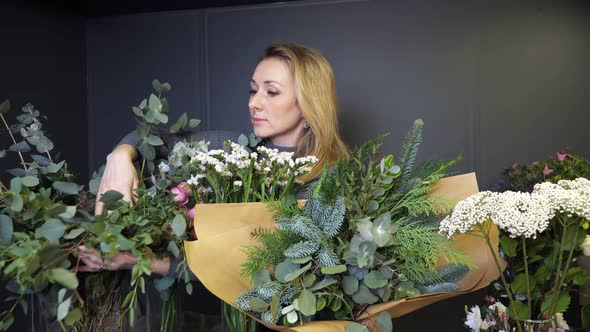 Florist Arranges Flowers and Twigs to Make Spring Bouquet