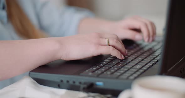 Young Businesswoman Typing Response To Client Email. Woman Typing on Keyboard.