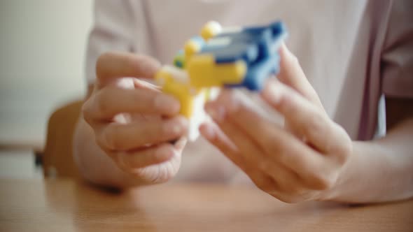 Close Up of Young Woman Plays with Puzzle on Table