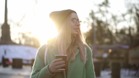 Woman Walking with Hot Drink By Winter City Park Enjoy Weather