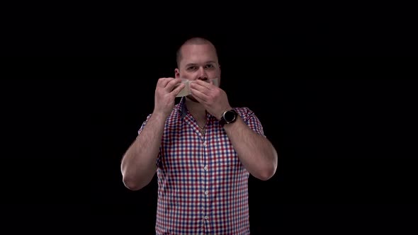 Man in Plaid Shirt with Beard on Black Isolate Background Seals Duct Tape with His Mouth. Silence Is