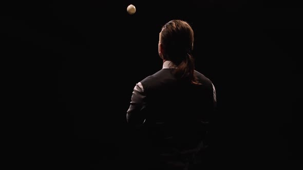 Orbital Shot of a Stylish Man Professionally Juggling White Balls