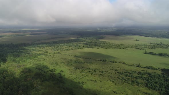 Smooth and Slow Take-off Over the Field and Forest. Plain Rural Landscape, Sunny Summer Day