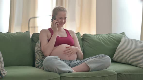 Pregnant Woman Talking on Phone at Home