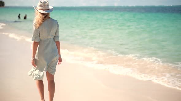 Woman Relaxing On Bahamas Flowing Dress Blowing In Wind. Girl Walking Tropical Bahamas Beach.