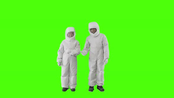 Guy and Girl in Spacesuits Play a Game with Their Hands 