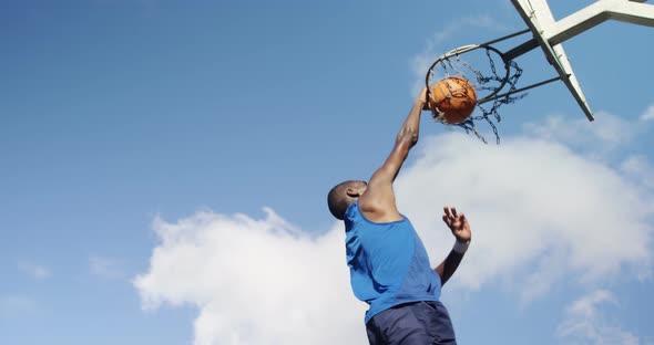 Basketball player scoring a dunk