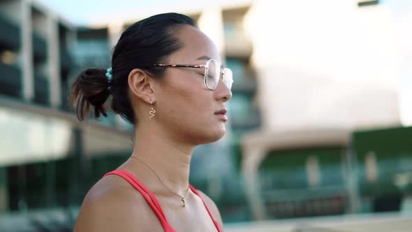 Calm Young Woman Taking Deep Breath of Fresh Air and Doing Yoga