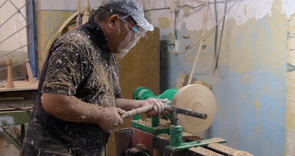 Carpenter turning wood on a lathe