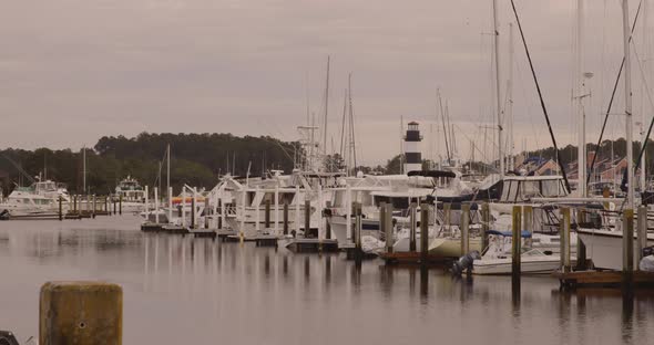 Coastal marina with boats and lighthouse