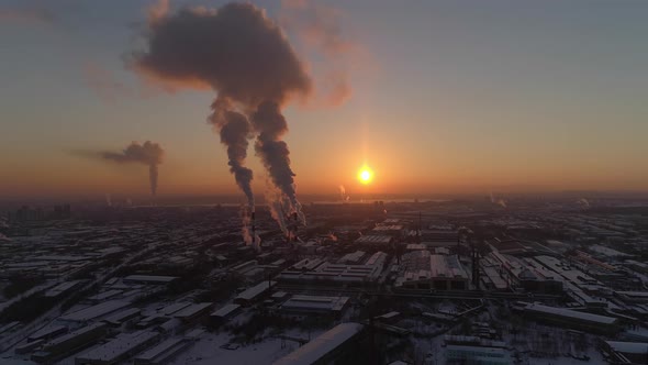 Aerial view of Smoke comes from the pipes of the factory at sunset 06