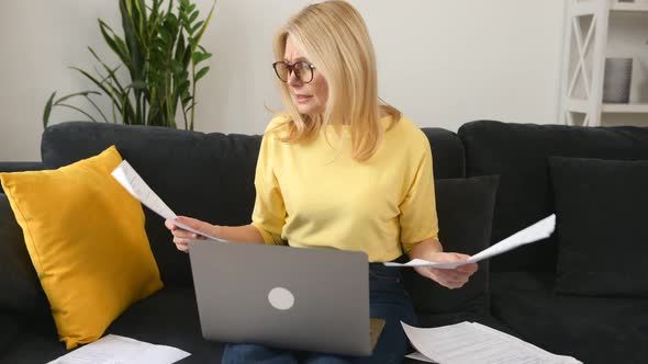 Busy Focused Mature Businesswoman Reading and Checking Papers