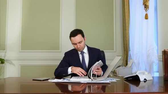 Businessman Overwhelmed By Paperwork