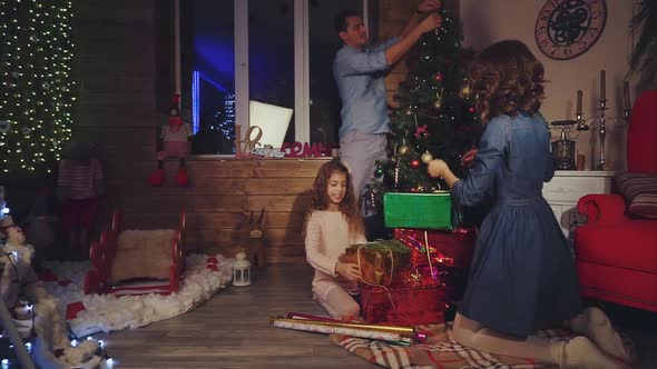 Family Decorate the House for Christmas New Year Scene