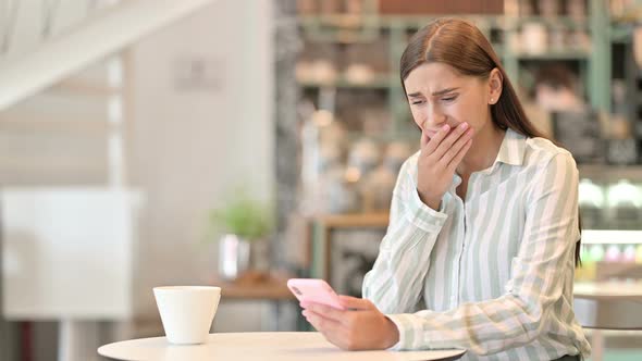 Disappointed Young Latin Woman Having Loss on Smartphone 