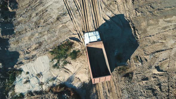 AERIAL View An Empty Truck Carrying Large Loads of Sand or Clay