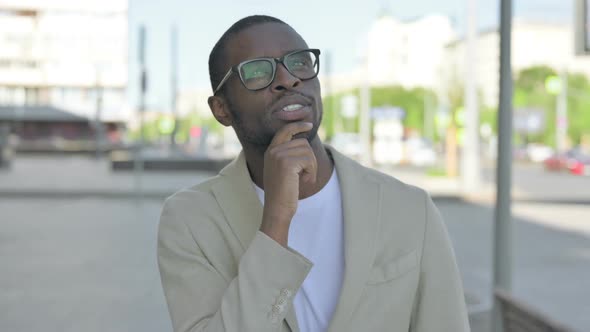 Portrait of Pensive African Man Thinking Outdoor