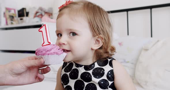 A Birthday Party for a Cute and Happy 1 Year Old Girl and Eating a Little Cake