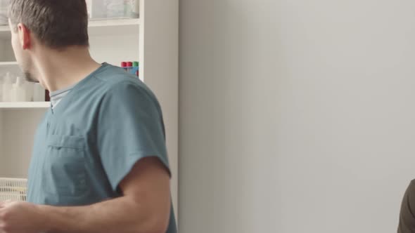 Army Doctor Giving Medication to Soldier alt